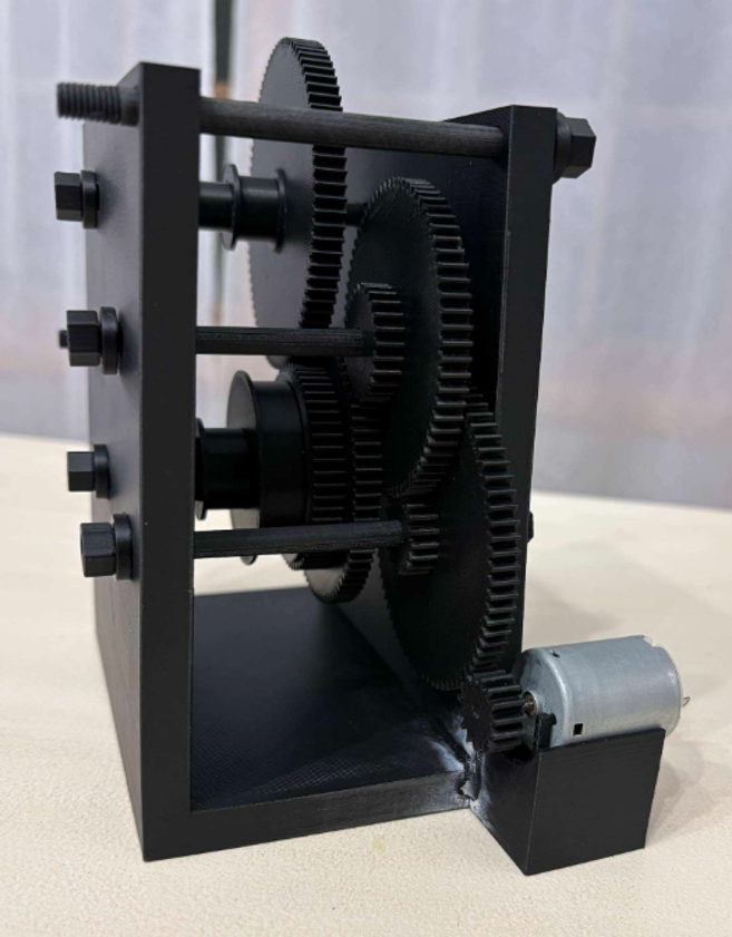Assembled gear-driven winch prototype with its motor, gears, and frame.